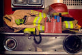 Firefighter gear with red helmet and tool pouch for essential firefighting tools