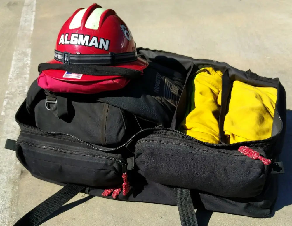 Wildland gear bag with zipper pockets and hand grips for firefighting equipment