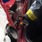 Firefighter using trauma shears with black titanium coated blades on damaged car panel