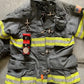 Firefighter’s gray turnout coat with THE MINIMALIST Leather Inverted flashlight holder