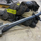 Firefighter’s Halligan tool beside turnout gear showcasing FMT Lanyard Strap and eye opening