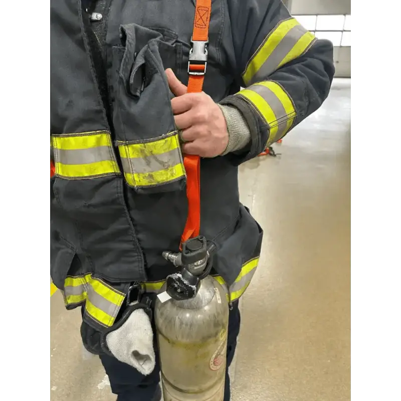 Firefighter’s protective gear with SCBA bottles and reflective stripes in a carrying sling