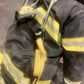 Firefighter’s protective suit with harness for personal carry in fireground applications