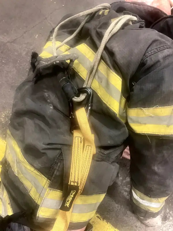Firefighter’s protective suit with harness for personal carry in fireground applications