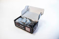 Black and white FireWrap® SFT box open with tissue paper wrapping contents inside