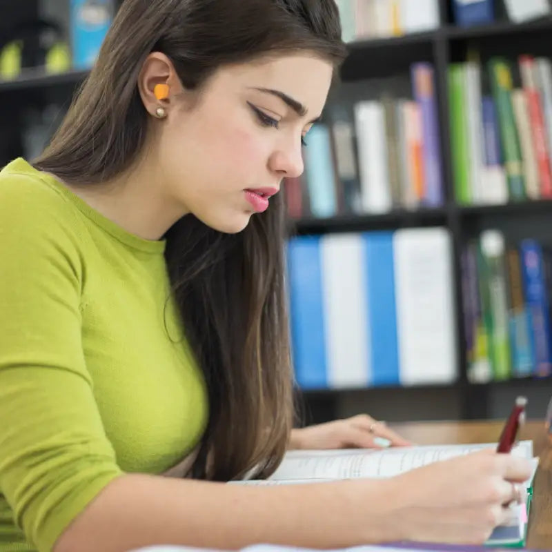 Focused student using 32db NRR soft foam earplugs for enhanced concentration