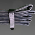 Folded gray fire hose with black and silver strap, FRE Adjustable Hose Strap for easy use