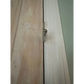 Door latch mechanism on a white frame with Gap GOAT System Mini Forcible Entry Wedge