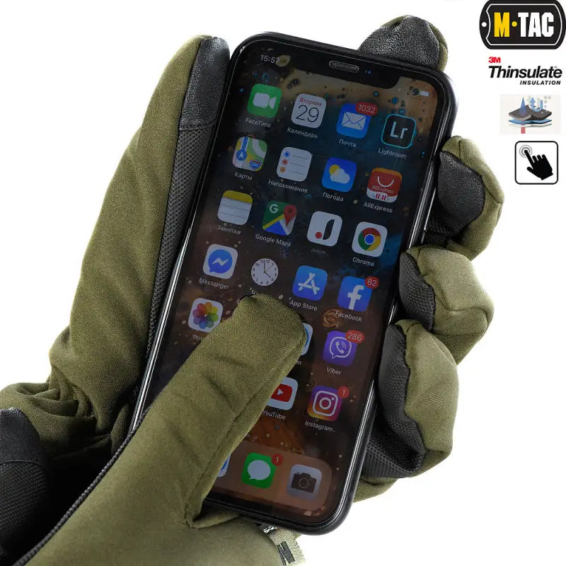 Gloved hand using M-Tac Gloves Soft Shell Thinsulate to operate an iPhone with apps