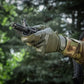 Gloved hand with M-Tac Gloves Police Gen.2 holding rifle barrel against green backdrop