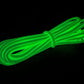 Coiled Glow Dacron® rope glowing green, showcasing enhanced resistance in an emergency pack