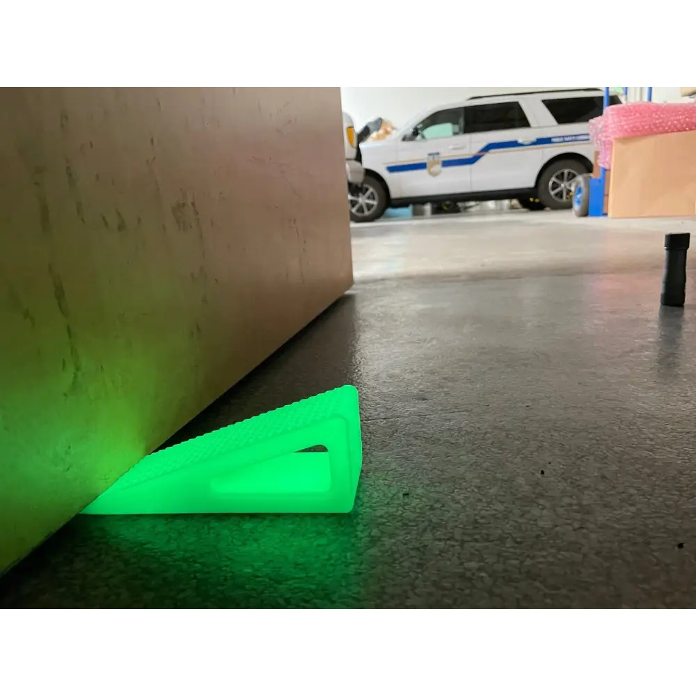 Neon green Glow - Extreme Grip doorstop wedge on floor made of high durometer silicone