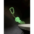 Glow-in-the-dark ghost keychain dangling from Williams Wedge, ideal for first responders