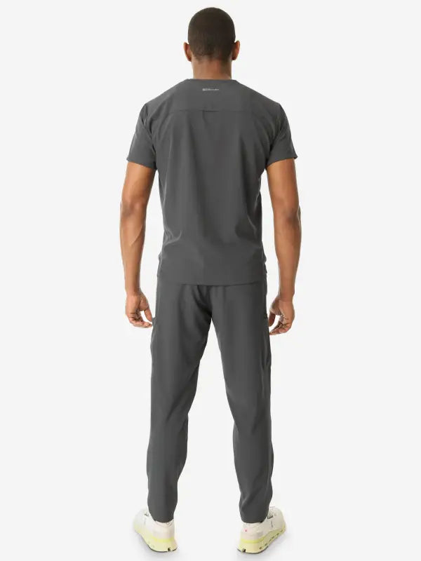 Gray athletic outfit featuring a men’s double-pocket scrub top and jogger pants