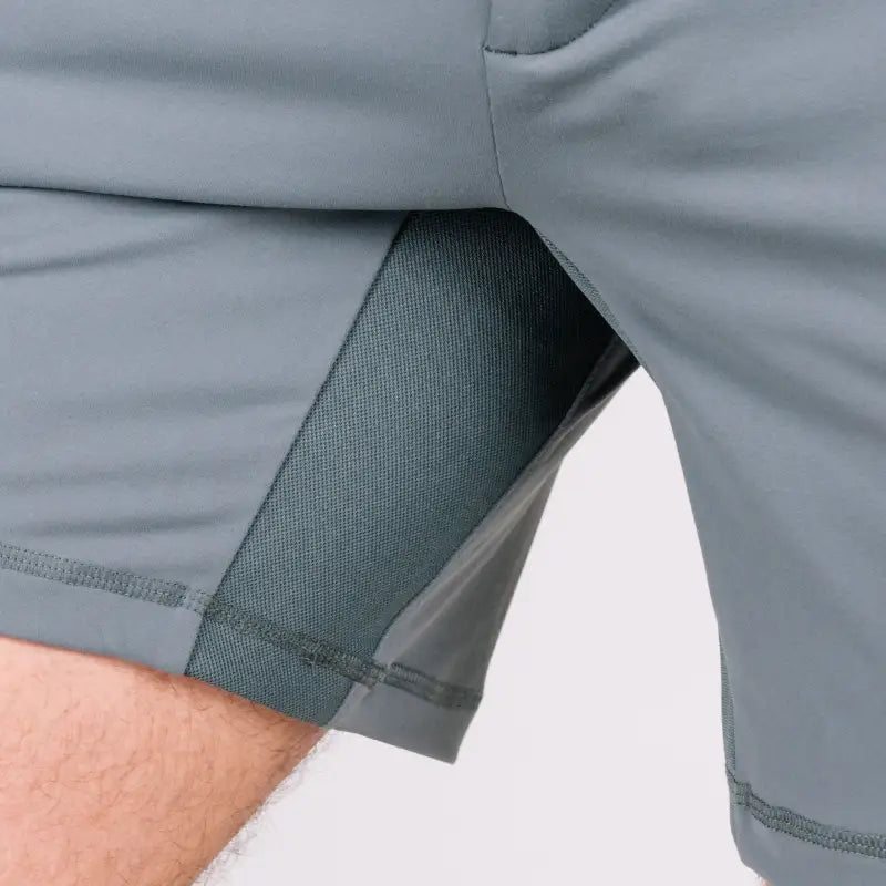 Gray athletic shorts shown in Carrier Shorts Mk.II with concealed carry features by Arrowhead Tactical Apparel