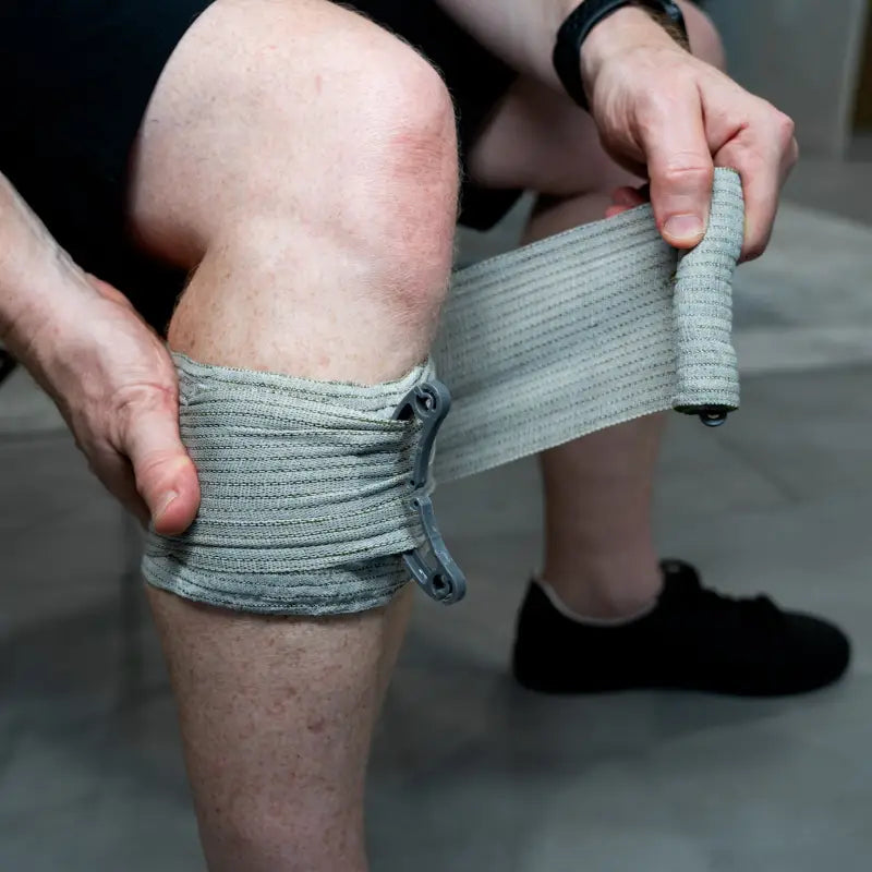 Gray elastic bandage wraps knee in The First Responder IFAK Kit for emergency aid