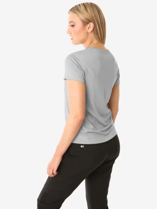 Gray women’s short-sleeve underscrub paired with stylish black pants for a chic look