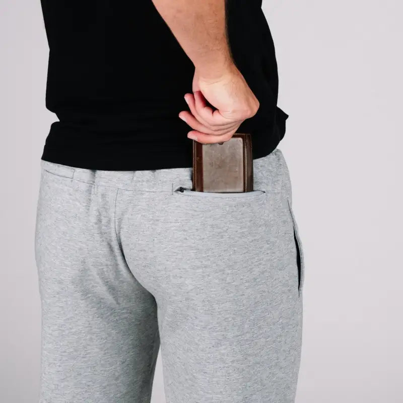 Gray sweatpants with patented carrier retention waistband and wallet in pocket