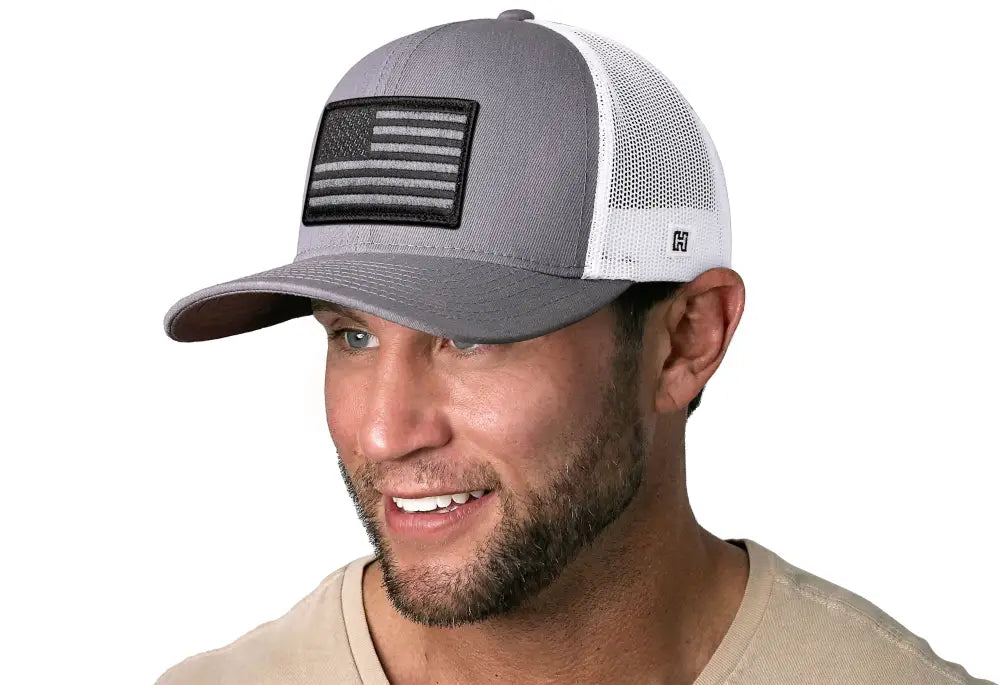 Gray and white USA snapback featuring an American Flag trucker patch design