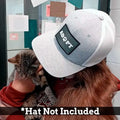 Gray and white trucker hat with a black logo patch for Adopt Paw’s quick style