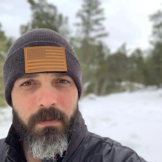 Gray winter beanie with an orange leather removable patch on velcro loop surface