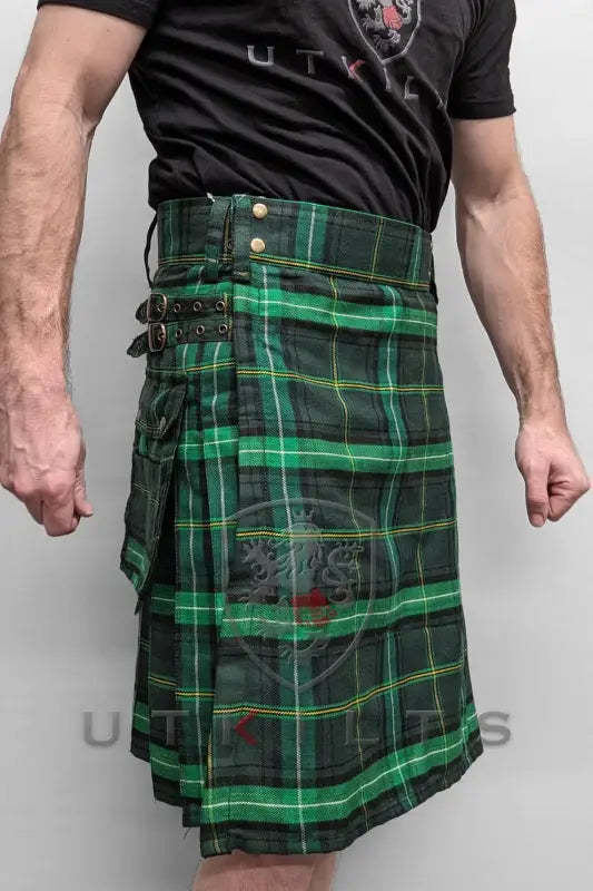 Green and black plaid utility kilt featuring cargo pockets and straps in Celtic Tartan design