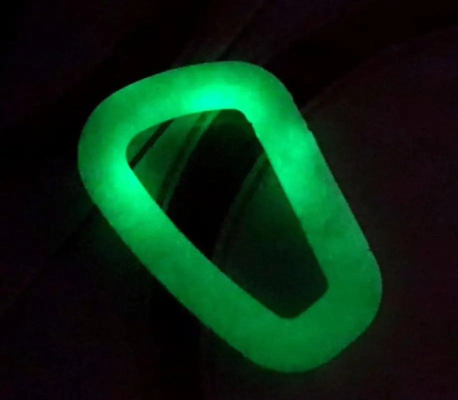 Glowing green polymer D-ring carabiner bracelet emitting vibrant neon light