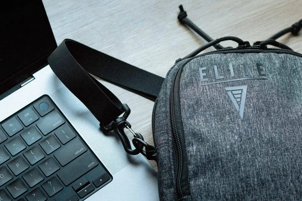 Grey textured Avenger Concealment Gun Pack next to a laptop keyboard