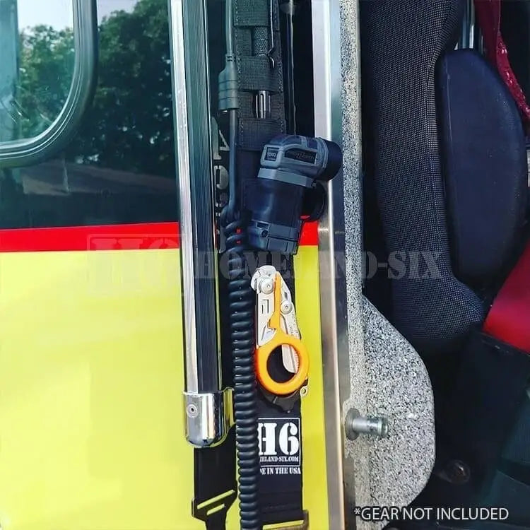 Yellow and black firefighter radio strap with coiled tether for secure use