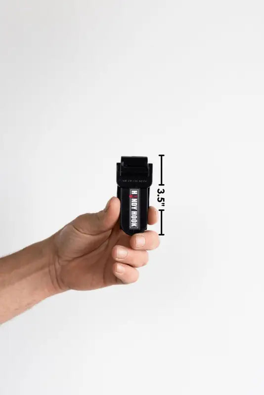 Hand holding a black pepper spray canister from the Handy Hook Firefighter Set