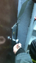Hand in black sleeve reaching for blue beam with FirePik World Famous Lock Loiding Tool