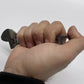 Hand holding a dark metallic USB flash drive for Adjustable Wrench - Titanium 6 Inch NSN Pending