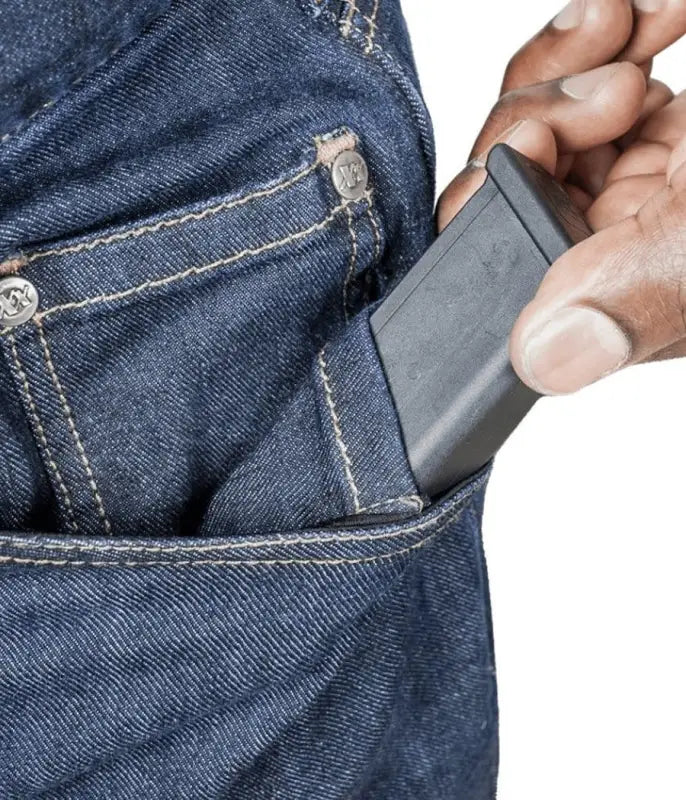 Hand removing a wallet from the pocket of Asset Tactical Jeans for convenience