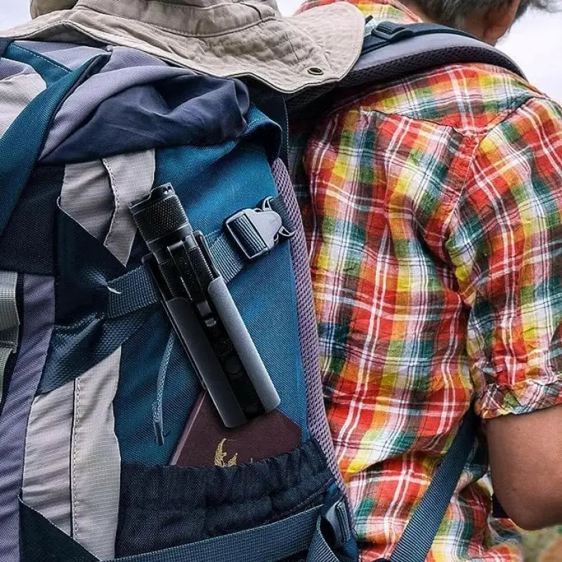 Handgun in engineered plastic clip-on holster on blue backpack with plaid shirt