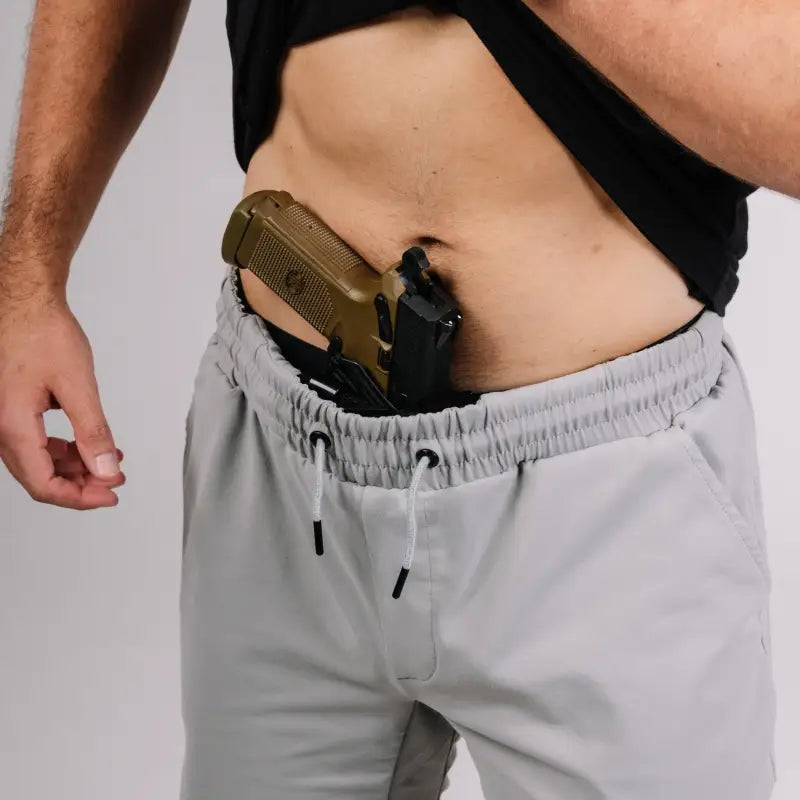 Handgun concealed in Carrier Shorts Chalk Grey 8 with patented carrier retention waistband