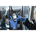 Handheld medical monitor in blue gloves, showcasing IV Pump Case with protective cover