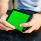 Hands holding a Captain Mens Wallet in Coyote Combat Leather with green screen display