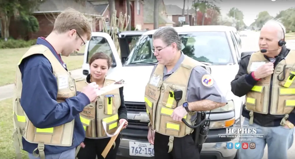 Emergency responders in HCPHES Safety Vests reviewing information together