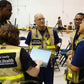 Group of emergency responders in HC PHES Safety Vests discussing safety protocols