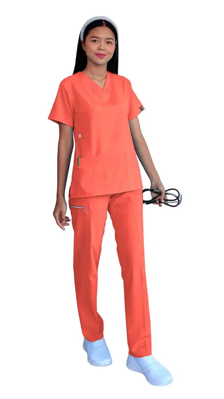 Healthcare worker in coral medical scrubs showcasing Women’s Gentle Stretch Slim Fit Zipper Set