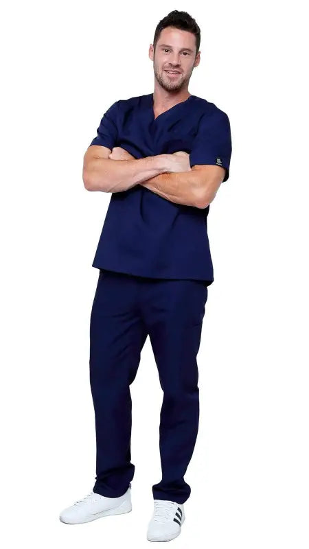 Healthcare worker in navy blue classic uniform scrubs and white sneakers