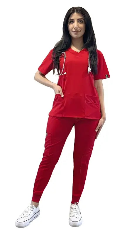 Healthcare worker in red extreme stretch jogger scrubs and white sneakers