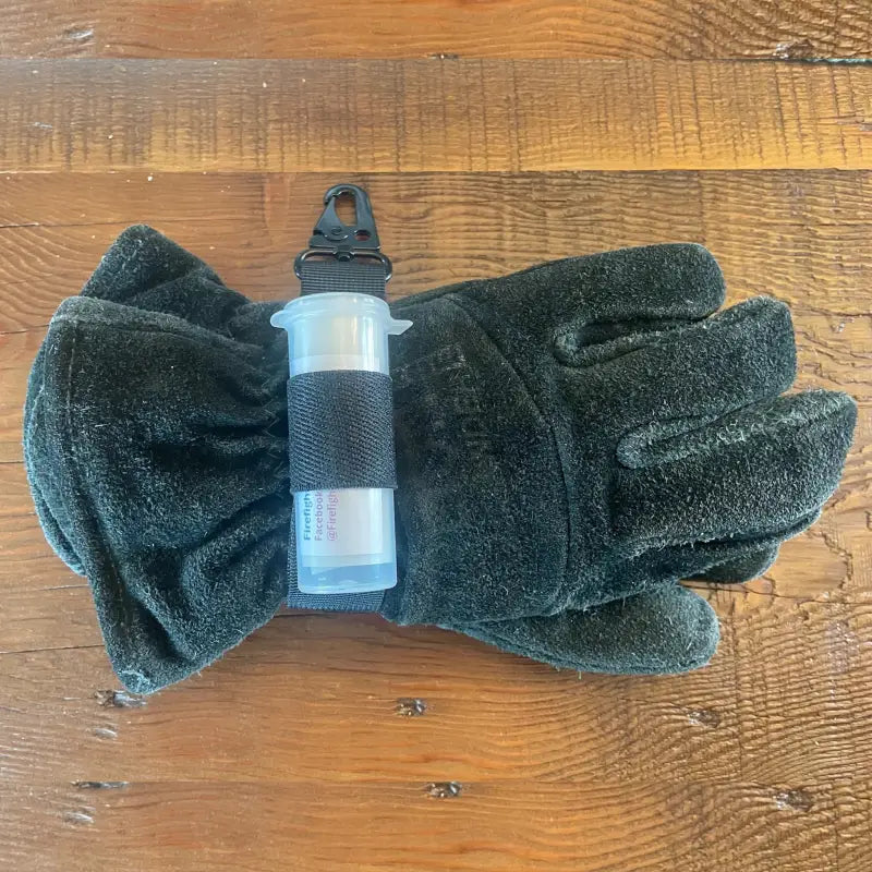 Black fleece gloves and water bottle secured with Firefighter Glove Strap and Swipe Tool Attachment