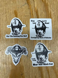 Four firefighter helmet stickers featuring slogans on a wooden surface