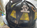 Black firefighter helmet with reflective markings and sticker for first responders