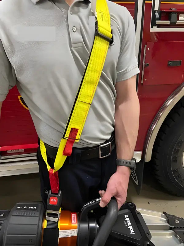 High-visibility yellow safety harness with red accents for extrication tool carrying strap