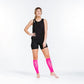 Hot pink compression calf sleeves worn with black workout attire for optimal support