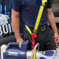 Hydraulic rescue tool with blue and silver components on yellow extrication tool carrying strap