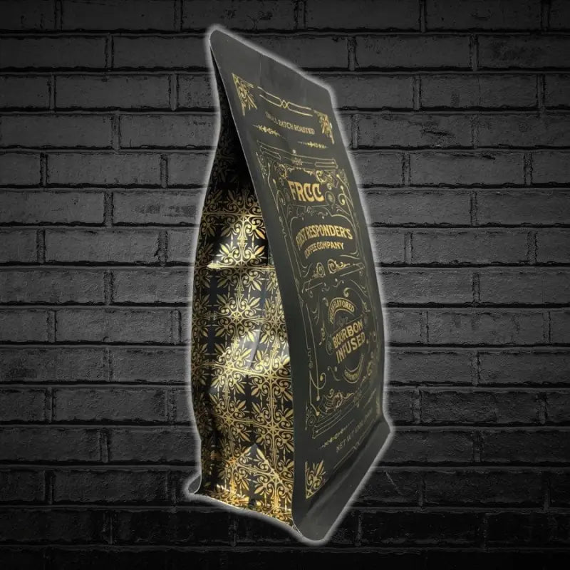 Illuminated black and gold book stand showcasing 12oz Bourbon Infused Pecan Coffee