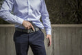 Handgun in IWB Holster Kit worn with dress pants and blue shirt, fits Beretta